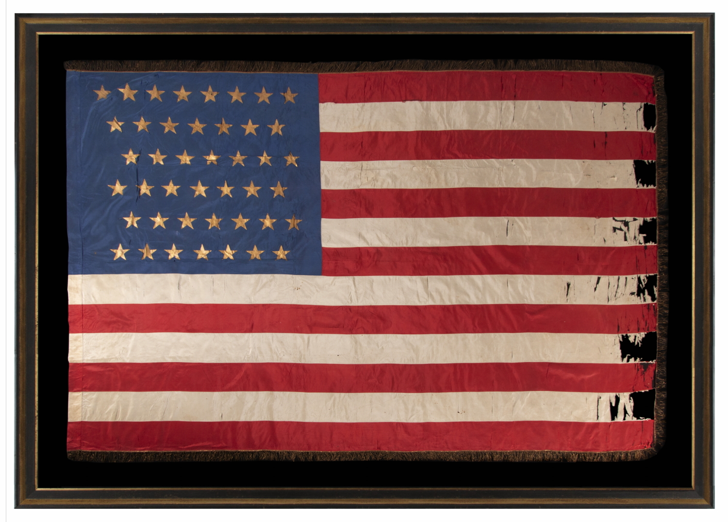 43 GILT-PAINTED STARS ON A SILK, ANTIQUE AMERICAN FLAG WITH BULLION FRINGE; REFLECTS THE ADDITION OF IDAHO AS THE 43RD STATE ON JULY 3RD, 1890, ONE OF THE RAREST STAR COUNTS AMONG SURVIVING AMERICAN FLAGS OF THE 19TH CENTURY