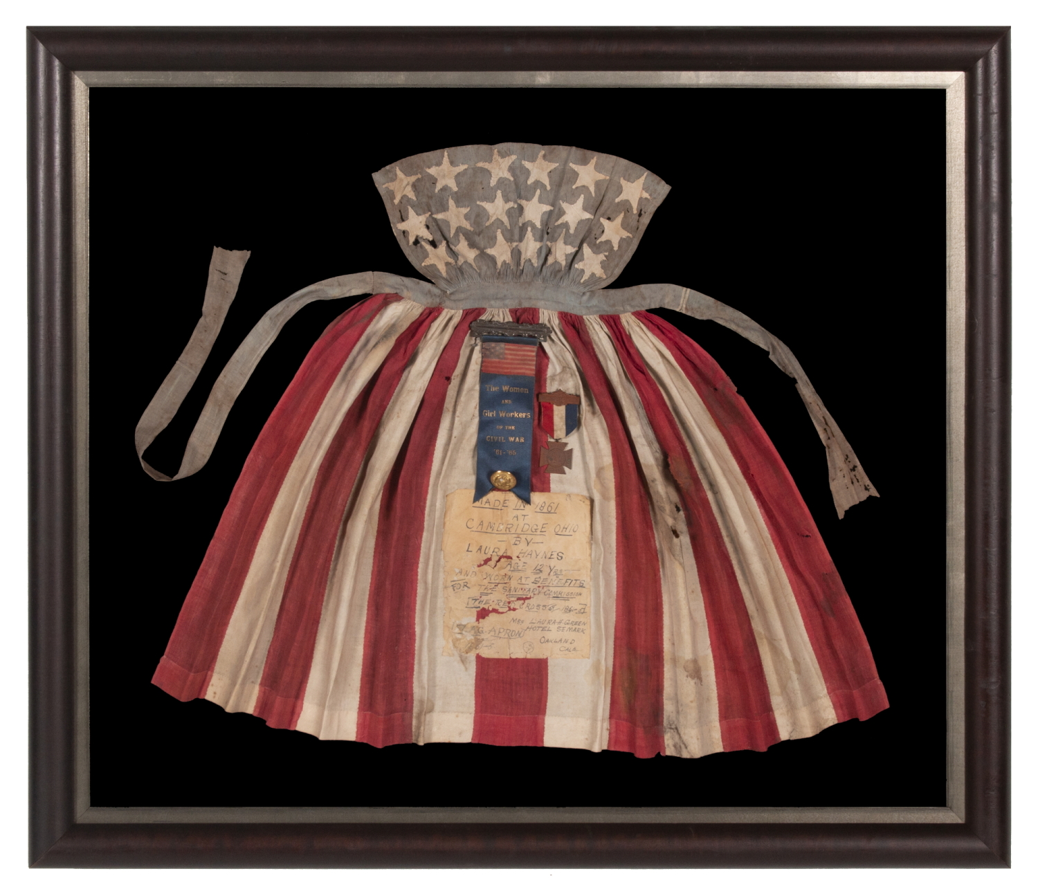 CIVIL WAR PERIOD APRON, MADE IN CAMBRIDGE, OHIO IN 1861 BY 12-YEAR-OLD LAURA HAYNES, WORN BY HER AT BENEFITS FOR THE U.S. SANITARY COMMISSION, PREDECESSOR OF THE RED CROSS, THAT STAFFED, FUNDED, AND MODERNIZED CIVIL WAR HOSPITALS