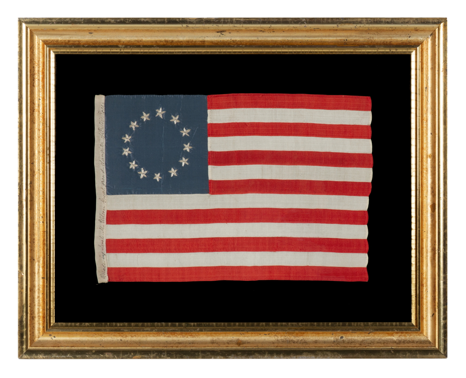 13 HAND-EMBROIDERED STARS AND EXPERTLY HAND-SEWN STRIPES ON AN ANTIQUE AMERICAN FLAG MADE IN PHILADELPHIA BY SARAH M. WILSON, GREAT-GRANDDAUGHTER OF BETSY ROSS, SIGNED & DATED 1910; THE LARGEST KNOWN EXAMPLE OF THIS VARIETY, MADE AND SOLD TO TOURISTS AT INDEPENDENCE HALL