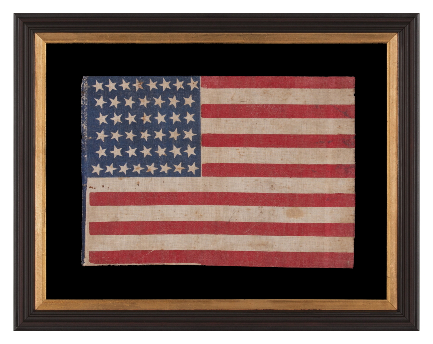 44 STAR ANTIQUE AMERICAN FLAG WITH AN HOURGLASS FORMATION ON A BRILLIANT BLUE CANTON; REFLECTS THE ERA WHEN WYOMING WAS THE MOST RECENT STATE TO JOIN THE UNION, 1890-1896