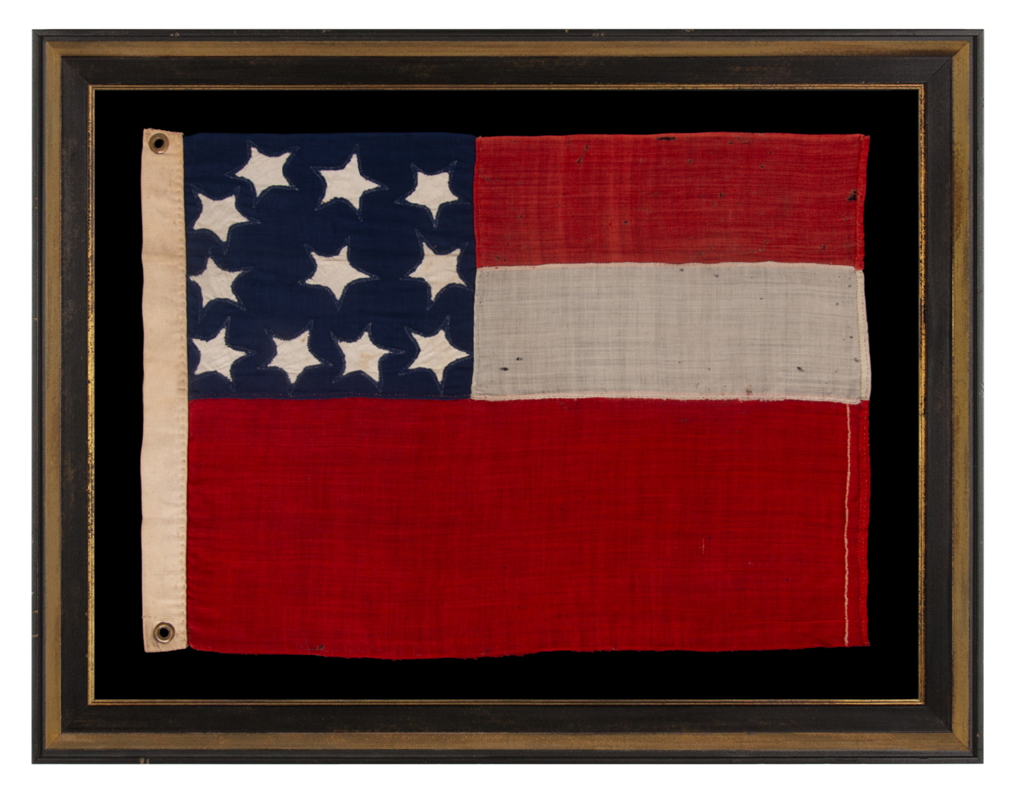 VERY RARE CONFEDERATE NAVAL ENSIGN IN THE FIRST NATIONAL (STARS & BARS) PATTERN, IN AN EXTRAORDINARY, SMALL SIZE, WITH 11 WHIMSICAL, SINGLE-APPLIQUÉD STARS AND A CURIOUSLY WIDE RED BAR, ENTIRELY HAND-SEWN, MADE BETWEEN MAY - NOVEMBER OF 1861:
