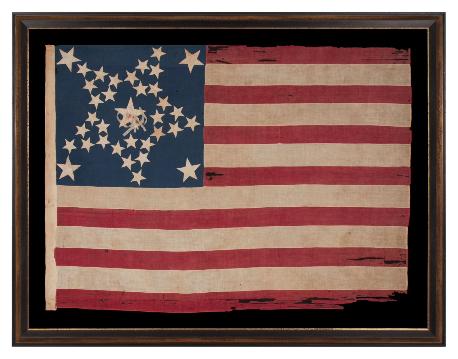 35 STARS IN A DYNAMIC “GREAT STAR” PATTERN, WITH A HUGE CENTER STAR THAT HAS AN UNUSUAL RIBBON ROSETTE, AND LARGE STARS FLANKING IN EACH CORNER, ON A CIVIL WAR PERIOD FLAG, HANDED DOWN THROUGH THE FAMILY OF LT. JOHN POLLOCK (KILLED AT THE BATTLE OF FAIR OAKS, VIRGINIA), SAID TO HAVE BEEN CARRIED BY COMPANY “A” OF THE 61ST PENNSYLVANIA VOLUNTEERS; THIS REGIMENT LOST MORE OFFICERS THAN ANY OTHER IN FEDERAL SERVICE