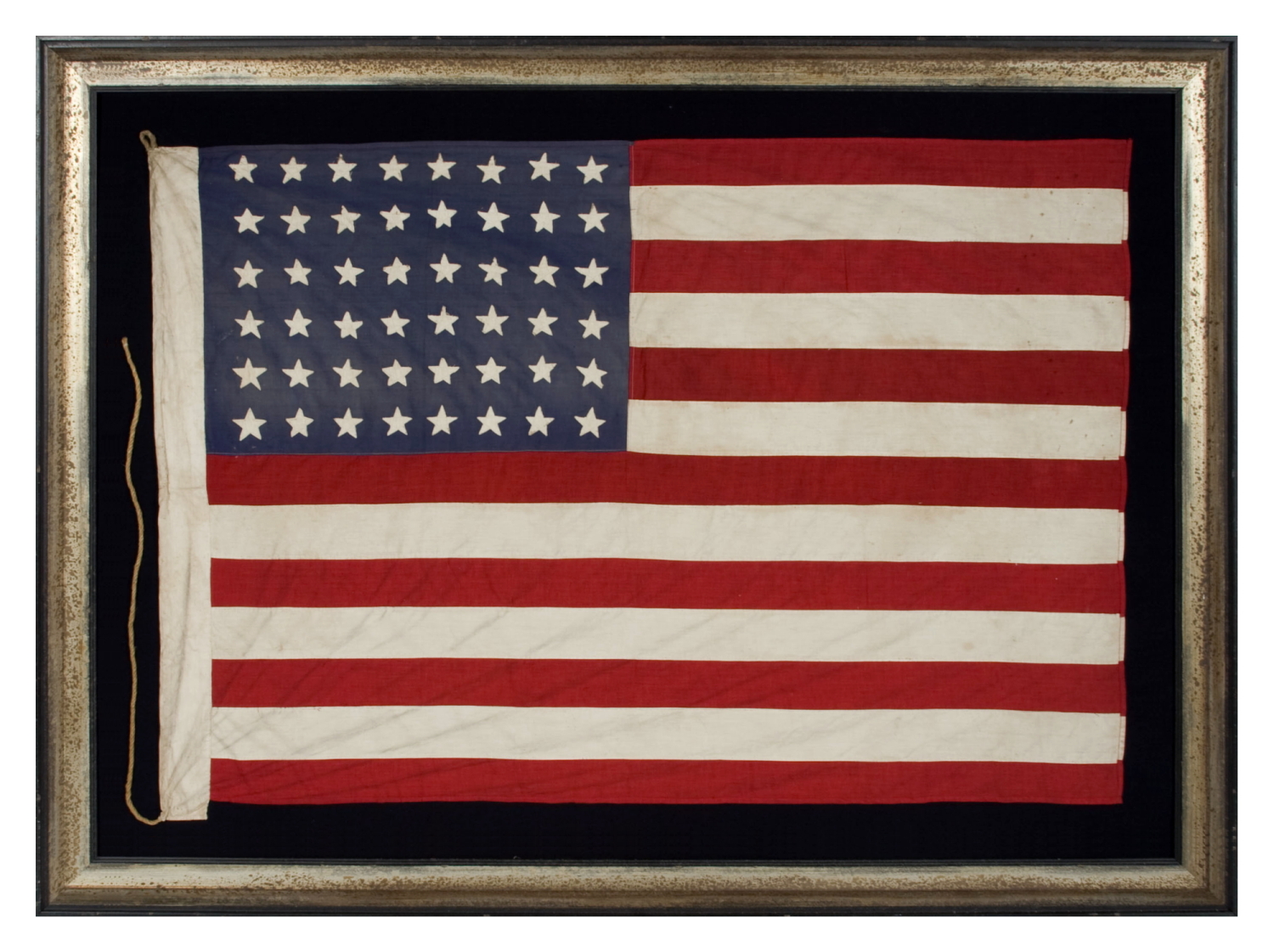 48 STAR AMERICAN NATIONAL FLAG WITH ITS CANTON RESTING ON THE WAR STRIPE, POSSIBLY MADE IN FRANCE DURING WWII TO WELCOME U.S. TROOPS IN THE WAKE OF LIBERATION FROM THE NAZIS, WITH VERBAL HISTORY TO NORMANDY