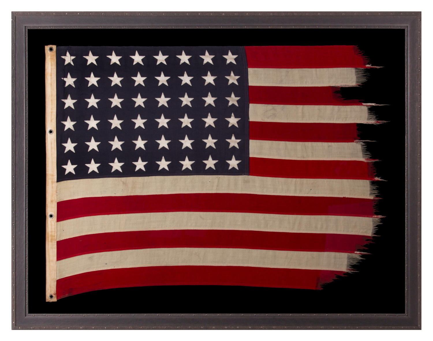 ANTIQUE AMERICAN FLAG WITH 48 STARS, A U.S. NAVY SMALL BOAT ENSIGN, MADE IN JANUARY OF 1944, DURING WWII (U.S. INVOLVEMENT 1941-45), AT MARE ISLAND, CALIFORNIA, FORMER HEADQUARTERS OF THE PACIFIC FLEET, WITH ENDEARING WEAR FROM LONG-TERM USE
