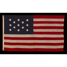 13 HAND-SEWN STARS IN A 3-2-3-2-3 PATTERN ON A U.S. NAVY SMALL BOAT ENSIGN OF THE CENTENNIAL ERA, MADE circa 1870-1882, IN A VARIANT OF THE SMALLEST REGULATION SIZE
