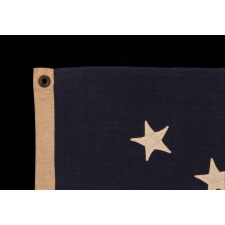 13 HAND-SEWN STARS IN A 3-2-3-2-3 PATTERN ON A U.S. NAVY SMALL BOAT ENSIGN OF THE CENTENNIAL ERA, MADE circa 1870-1882, IN A VARIANT OF THE SMALLEST REGULATION SIZE