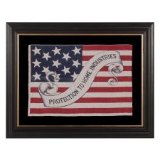 13 STAR AMERICAN PARADE FLAG IN AN EXTREMELY RARE DESIGN, WITH “PROTECTION TO HOME INDUSTRIES” SLOGAN ON A FANCIFUL, SCROLLING STREAMER, MADE FOR THE 1888 PRESIDENTIAL CAMPAIGN OF BENJAMIN HARRISON; FORMERLY IN THE COLLECTION OF RICHARD PIERCE
