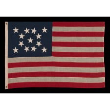 13 STAR ANTIQUE AMERICAN FLAG, MADE IN THE ERA OF THE 1876 CENTENNIAL, WITH HAND-SEWN STARS IN A MEDALLION CONFIGURATION, IN A DESIRABLE SCALE AMONG ITS COUNTERPARTS OF THE PERIOD