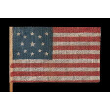 13 STAR ANTIQUE AMERICAN FLAG WITH A MEDALLION CONFIGURATION OF STARS, MADE FOR THE 1876 CENTENNIAL CELEBRATION