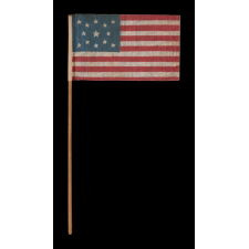 13 STAR ANTIQUE AMERICAN FLAG WITH A MEDALLION CONFIGURATION OF STARS, MADE FOR THE 1876 CENTENNIAL CELEBRATION