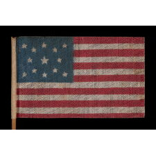 13 STAR ANTIQUE AMERICAN FLAG WITH A MEDALLION CONFIGURATION OF STARS, MADE FOR THE 1876 CENTENNIAL CELEBRATION