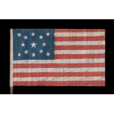 13 STAR ANTIQUE AMERICAN FLAG WITH A MEDALLION CONFIGURATION OF STARS, MADE FOR THE 1876 CENTENNIAL CELEBRATION