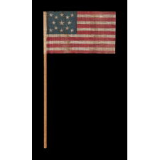 13 STAR ANTIQUE AMERICAN FLAG WITH A MEDALLION CONFIGURATION OF STARS, MADE FOR THE 1876 CENTENNIAL CELEBRATION