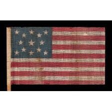 13 STAR ANTIQUE AMERICAN FLAG WITH A MEDALLION CONFIGURATION OF STARS, MADE FOR THE 1876 CENTENNIAL CELEBRATION
