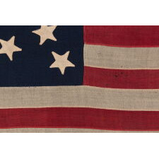 13 STAR ANTIQUE AMERICAN FLAG WITH AN ATTRACTIVE & WHIMSICAL PRESENTATION OF THE MEDALLION CONFIGURATION; A SMALL-SCALE EXAMPLE, LAST DECADE 19th CENTURY