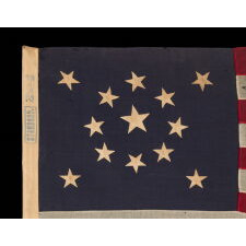 13 STAR ANTIQUE AMERICAN FLAG WITH A MEDALLION CONFIGURATION OF STARS; A SMALL-SCALE EXAMPLE, MADE CIRCA 1895-1926