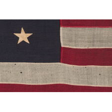 13 STAR ANTIQUE AMERICAN FLAG WITH A MEDALLION CONFIGURATION OF STARS; A SMALL-SCALE EXAMPLE, MADE CIRCA 1895-1926