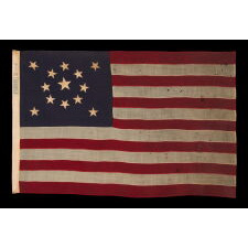 13 STAR ANTIQUE AMERICAN FLAG WITH A MEDALLION CONFIGURATION OF STARS; A SMALL-SCALE EXAMPLE, MADE CIRCA 1895-1926