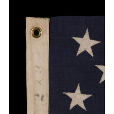 13 STAR ANTIQUE AMERICAN FLAG WITH A 3-2-3-2-3 CONFIGURATION OF STARS ON AN INDIGO CANTON, SQUARISH PROPORTIONS, AND A BEAUTIFUL OVERALL PRESENTATION, MADE circa 1895-1926