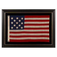 13 STAR ANTIQUE AMERICAN FLAG WITH A 3-2-3-2-3 CONFIGURATION OF STARS; A SMALL-SCALE EXAMPLE, MADE IN THE 1895-1926 ERA, MARKED “R.H. MACY & CO.”