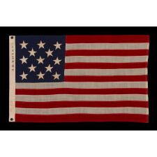 13 STAR ANTIQUE AMERICAN FLAG WITH A 3-2-3-2-3 CONFIGURATION OF STARS; A SMALL-SCALE EXAMPLE, MADE IN THE 1895-1926 ERA, MARKED “R.H. MACY & CO.”