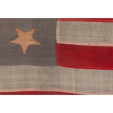 13 STAR ANTIQUE AMERICAN FLAG, WITH A 3-2-3-2-3 CONFIGURATION OF STARS ON A BEAUTIFUL, DUSTY BLUE CANTON, A SMALL-SCALE EXAMPLE OF THE LATE 19TH CENTURY