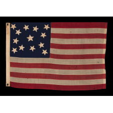 13 STAR ANTIQUE AMERICAN FLAG WITH AN ATTRACTIVE & WHIMSICAL PRESENTATION OF THE MEDALLION CONFIGURATION; A SMALL-SCALE EXAMPLE, LAST DECADE 19th CENTURY