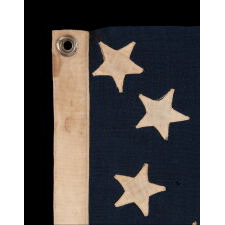 13 STAR ANTIQUE AMERICAN FLAG WITH AN ATTRACTIVE & WHIMSICAL PRESENTATION OF THE MEDALLION CONFIGURATION; A SMALL-SCALE EXAMPLE, LAST DECADE 19th CENTURY