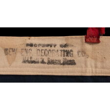 13 STAR ANTIQUE AMERICAN FLAG WITH A 3-2-3-2-3 CONFIGURATION AND AN INK-STAMPED MARK OF THE NEW ENGLAND DECORATING COMPANY OF MASSACHUSETTS, WITH HAND-SEWN, TWILL TAPE TIES, MADE IN THE LAST DECADE OF THE 19TH CENTURY, circa 1892-1899