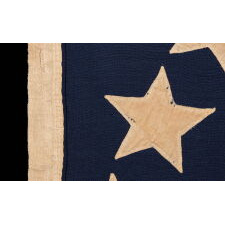 13 STAR ANTIQUE AMERICAN FLAG WITH A BROAD, ARCHED FORMATION OF HAND-SEWN, SINGLE-APPLIQUÉD STARS, ARCH ABOVE A BEAUTIFULLY HAND-SEWN FEDERAL EAGLE, ATTRIBUTED TO FLAG-MAKER SARAH McFADDEN – “NEW YORK’S BETSY ROSS” – AT 198 HUDSON STREET IN MANHATTAN, circa 1870-1880; EXHIBITED AT THE MUSEUM OF THE AMERICAN REVOLUTION FROM JUNE – JULY, 2019