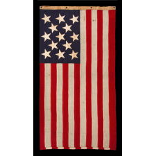 13 STAR ANTIQUE AMERICAN FLAG w/ A 3-2-3-2-3 PATTERN OF ESPECIALLY LARGE STARS; A U.S. NAVY SMALL BOAT ENSIGN, SIGNED & DATED 1903, MADE AT THE BROOKLYN NAVY YARD IN NEW YORK CITY