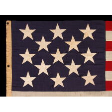 13 STAR ANTIQUE AMERICAN FLAG w/ A 3-2-3-2-3 PATTERN OF ESPECIALLY LARGE STARS; A U.S. NAVY SMALL BOAT ENSIGN, SIGNED & DATED 1903, MADE AT THE BROOKLYN NAVY YARD IN NEW YORK CITY