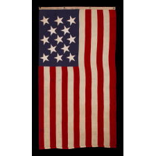 13 STAR ANTIQUE AMERICAN FLAG WITH A 3-2-3-2-3 PATTERN OF ESPECIALLY LARGE STARS; A U.S. NAVY SMALL BOAT ENSIGN, SIGNED & DATED 1914, MADE AT THE BROOKLYN NAVY YARD IN NEW YORK CITY