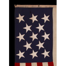 13 STAR ANTIQUE AMERICAN FLAG WITH A 3-2-3-2-3 PATTERN OF ESPECIALLY LARGE STARS; A U.S. NAVY SMALL BOAT ENSIGN, SIGNED & DATED 1914, MADE AT THE BROOKLYN NAVY YARD IN NEW YORK CITY