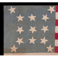 13 STAR ANTIQUE AMERICAN FLAG, A HOMEMADE EXAMPLE WITH AN INCREDIBLY RARE CONFIGURATION OF STARS THAT CONSISTS OF A BOX OF 9 WITH 4 OUTLIERS, SET AGAINST A LIGHT BLUE CANTON; LIKELY MADE IN CELEBRATION OF THE 1876 CENTENNIAL OF AMERICAN INDEPENDENCE; EXHIBITED AT THE MUSEUM OF THE AMERICAN REVOLUTION, JUNE-JULY 2019