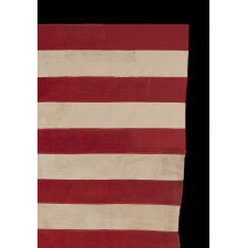 13 STAR ANTIQUE AMERICAN FLAG, A HOMEMADE EXAMPLE WITH AN INCREDIBLY RARE CONFIGURATION OF STARS THAT CONSISTS OF A BOX OF 9 WITH 4 OUTLIERS, SET AGAINST A LIGHT BLUE CANTON; LIKELY MADE IN CELEBRATION OF THE 1876 CENTENNIAL OF AMERICAN INDEPENDENCE; EXHIBITED AT THE MUSEUM OF THE AMERICAN REVOLUTION, JUNE-JULY 2019