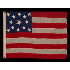 13 STAR ANTIQUE AMERICAN FLAG OF THE CIVIL WAR PERIOD (1861-1865), WITH 9 STRIPES TO REFLECT THE OMISSION OF NORTH & SOUTH CAROLINA, GEORGIA, & VIRGINIA, THE 4 SLAVE STATES AMONG THE ORIGINAL 13 COLONIES THAT SECEDED FROM THE UNION, WITH ITS CANTON RESTING ON THE WAR STRIPE, STRIKING COLOR, AND A BEAUTIFUL MEDALLION CONFIGURATION