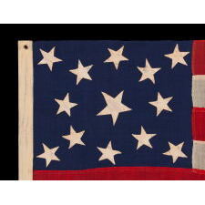 13 STAR ANTIQUE AMERICAN FLAG OF THE CIVIL WAR PERIOD (1861-1865), WITH 9 STRIPES TO REFLECT THE OMISSION OF NORTH & SOUTH CAROLINA, GEORGIA, & VIRGINIA, THE 4 SLAVE STATES AMONG THE ORIGINAL 13 COLONIES THAT SECEDED FROM THE UNION, WITH ITS CANTON RESTING ON THE WAR STRIPE, STRIKING COLOR, AND A BEAUTIFUL MEDALLION CONFIGURATION