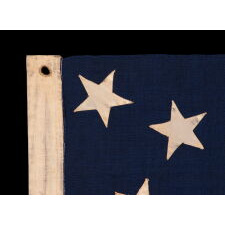 13 STAR ANTIQUE AMERICAN FLAG OF THE CIVIL WAR PERIOD (1861-1865), WITH 9 STRIPES TO REFLECT THE OMISSION OF NORTH & SOUTH CAROLINA, GEORGIA, & VIRGINIA, THE 4 SLAVE STATES AMONG THE ORIGINAL 13 COLONIES THAT SECEDED FROM THE UNION, WITH ITS CANTON RESTING ON THE WAR STRIPE, STRIKING COLOR, AND A BEAUTIFUL MEDALLION CONFIGURATION