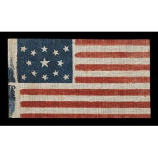 13 STAR ANTIQUE AMERICAN PARADE FLAG WITH A MEDALLION CONFIGURATION, MADE FOR THE 1876 CENTENNIAL OF AMERICAN INDEPENDENCE; A LARGE EXAMPLE AMONG ITS COUNTERPARTS OF THE PERIOD; PRESENTED IN THE FIRST EVER LARGE SCALE MUSEUM EXHBITION OF EARLY 13 STAR FLAGS