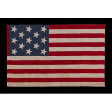 13 STAR ANTIQUE AMERICAN PARADE FLAG, WITH A 3-2-3-2-3 CONFIGURATION OF STARS, AN EXTREMELY SCARCE AND UNUSUALLY LARGE VARIETY, MADE circa 1876-1899