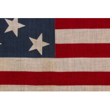13 STAR ANTIQUE AMERICAN PARADE FLAG, WITH A 3-2-3-2-3 CONFIGURATION OF STARS, AN EXTREMELY SCARCE AND UNUSUALLY LARGE VARIETY, MADE circa 1876-1899
