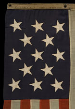 13 STAR U.S. NAVY SMALL BOAT ENSIGN MADE AT THE BROOKLYN NAVY YARD, NEW YORK, DATED 1907, PROBABLY PRODUCED TO OUTFIT TEDDY ROOSEVELT'S GREAT WHITE FLEET