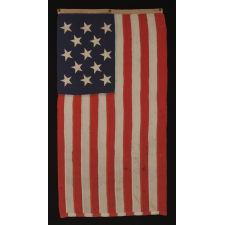 13 STAR U.S. NAVY SMALL BOAT ENSIGN MADE AT THE BROOKLYN NAVY YARD, NEW YORK, DATED 1907, PROBABLY PRODUCED TO OUTFIT TEDDY ROOSEVELT'S GREAT WHITE FLEET