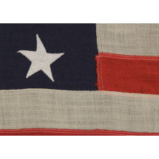 13 STARS ARRANGED IN A 3-2-3-2-3 PATTERN ON A SMALL-SCALE ANTIQUE AMERICAN FLAG MADE IN THE PERIOD BETWEEN THE LAST DECADE OF THE 19TH CENTURY AND THE FIRST QUARTER OF THE 20TH