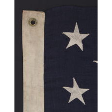 13 STARS ARRANGED IN A 3-2-3-2-3 PATTERN ON A SMALL-SCALE ANTIQUE AMERICAN FLAG MADE IN THE PERIOD BETWEEN THE LAST DECADE OF THE 19TH CENTURY AND THE FIRST QUARTER OF THE 20TH