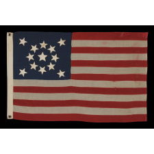 13 STARS ARRANGED IN A MEDALLION PATTERN, WITH A SLIGHTLY LARGER CENTER STAR, ON A SMALL-SCALE ANTIQUE AMERICAN FLAG MARKED "NAVY" [A BRAND NAME], MADE DURING THE LAST DECADE OF THE 19TH CENTURY