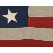 13 STARS ARRANGED IN A MEDALLION PATTERN, WITH A SLIGHTLY LARGER CENTER STAR, ON A SMALL-SCALE ANTIQUE AMERICAN FLAG MARKED "NAVY" [A BRAND NAME], MADE DURING THE LAST DECADE OF THE 19TH CENTURY