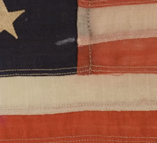 13 STARS IN THE BETSY ROSS PATTERN, AN EXTREMELY SCARCE SEWN EXAMPLE IN A TINY SIZE, 1895-1926