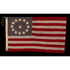 13 STARS ON A DUSTY BLUE CANTON, IN AN OVAL VERSION OF WHAT IS KNOWN AS THE 3RD MARYLAND PATTERN, MADE DURING THE LAST DECADE OF THE 19TH CENTURY, MARKED WITH THE SURNAME “NYE”